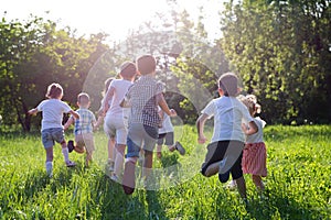 Children play outdoors running and having fun