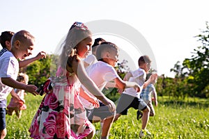Children play outdoors running and having fun