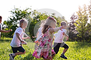 Children play outdoors running and having fun