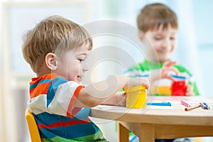 Children play and paint at home or kindergarten or playschool