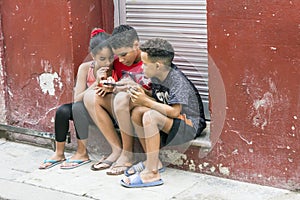 Children play with a phone in Havana, Cuba