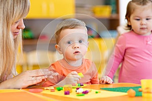 Children play with plasticine in kindergarten