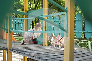 Children play in the playground. Amusement park. Leisure activities of little friends in the park.