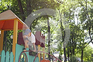 Children play in the playground. Amusement park. Leisure activities of little friends in the park.
