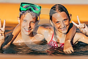 Children play in the pool. little boy and a girl have fun in the pool. Summer holidays and holiday concept