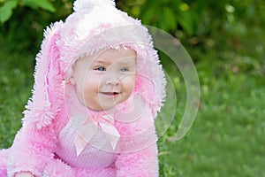 Children play with real rabbit. Laughing child at Easter egg hunt with pet bunny