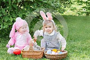 Children play with real rabbit. Laughing child at Easter egg hunt with pet bunny