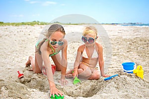 Children play with sand on beach