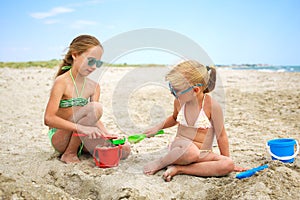 Children play with sand on beach