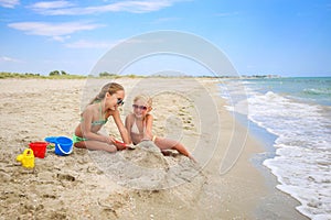 Children play with sand on beach