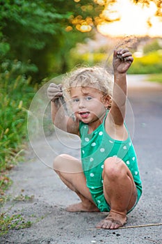 Children play with sand on the street. Selective focus.