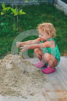 Children play with sand on the street. Selective focus.