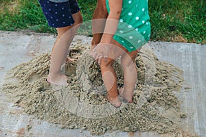 Children play with sand on the street. Selective focus.