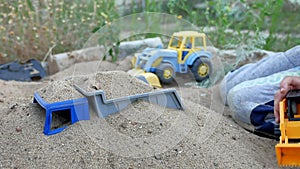 Children play in the sand toys. toys for child sandboxes against the beach sand background. kids summer holidays