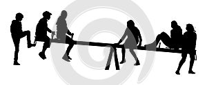 Children play on a seesaw. Girls and boys teenager swinging, silhouette.