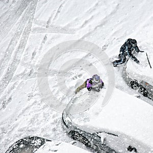 Children play in snow around cars in parking lot