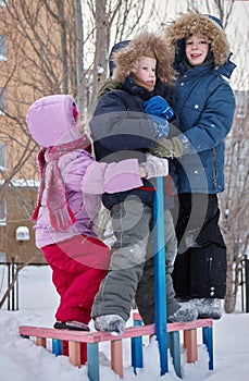 Children play in the snow. Winter day