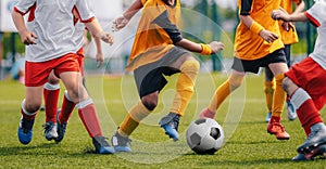 Children Play Soccer Game. Young Boys Running and Kicking Football Ball on Grass Sports Field