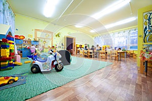 Children play to room where many toys. photo