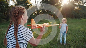 Children play with toy airplane in the park. happy family kid dream freedom airplane a concept. children play in the