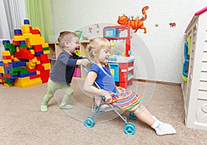 Children play with toy stroller in daycare