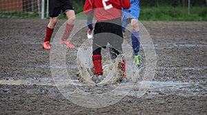 Children players during a football match in a playing field full