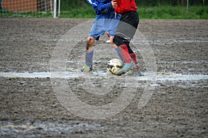 Children players during a football match in a playing field full