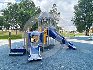 Children playground activities in public park. Slide, swing on modern playground