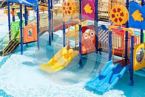 Children Playground with Colorful Yellow And Blue Plastic Slider in Swimming Pool