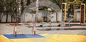 Children playground yard with soccer football goal, swings and s