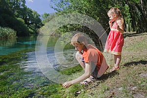 Children playing active game on Tirino river bank in Italian Abruzzo