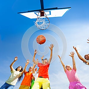 Children playing basketball view from bottom