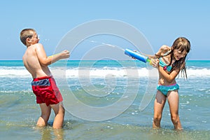 Children playing on the beach waterfighting