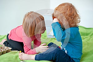 Children playing on the bed