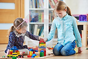 Children playing with blocks indoors