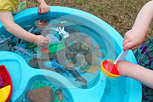 Children Playing with Boats and Sea Creature/Ocean Life Toys in a Water Table