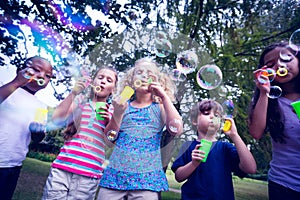 Children playing with bubble wand in the park