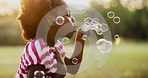 Children is playing bubbles in a park