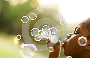 Children is playing bubbles in a park