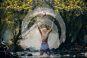 Children playing catch duck in river