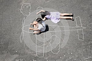 Children playing in a chalk airplane