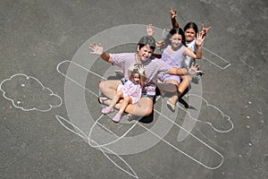 Children playing in a chalk airplane