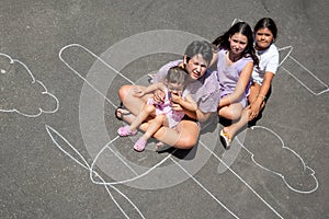 Children playing in a chalk airplane