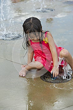 Children playing in a city water park play ground