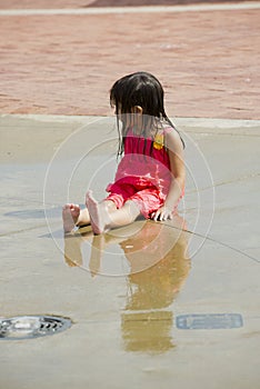 Children playing in a city water park play ground