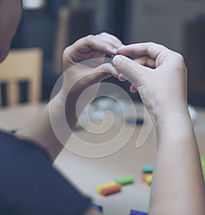 Children playing colorful clay on wood table.