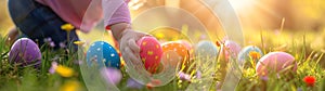 Children playing with colorful Easter eggs in a meadow.