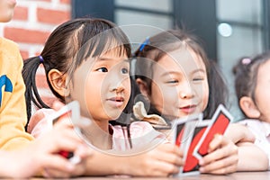 Children playing with counting card in class room