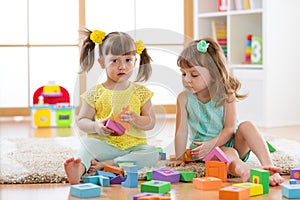 Kids playing with developmental toys at home or kindergarten or playschool photo
