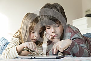 Children playing with a digital tablet